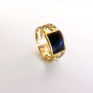 Macro detail of 18K gold-plated hollow chain ring with a black enamel rectangle finish