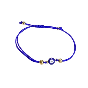 Adjustable woven blue Turkish Evil Eye bracelet with gold metal beads on white background