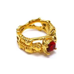Gothic punk gold skull ring featuring a faceted red stone and skeleton relief details