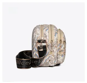 Side view of white crossbody bag showing three zipper layers and gold hardware