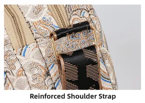 Detail view of reinforced shoulder strap with gold D-ring on vintage floral crossbody bag