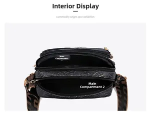 Top view of compact black crossbody bag showing two main zippered inner compartments