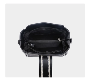 Top view of black PU leather crossbody bag showing multi-compartment interior and zip pocket