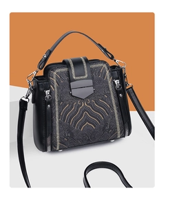 Detail of vintage black leather crossbody bag with traditional Chinese cloud embroidery