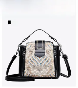 Front view of retro Chinese style handbag with detailed embroidery and leather texture