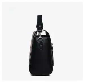 Side view of elegant black leather handbag featuring silver zipper and sturdy D-ring hardware