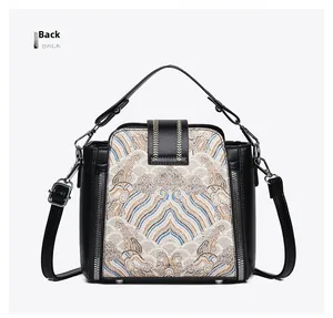 Detailed back view of a retro Chinese style handbag with embroidery and metal zippers
