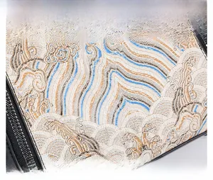 Close-up of premium waterproof fabric with elegant blue and gold oriental embroidery