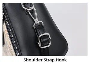 Close-up of the silver metal shoulder strap hook and zipper detail on black leather bag
