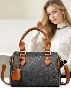 Detail of Boston bag with grey mountain pattern, brown leather trim, and gold rivets
