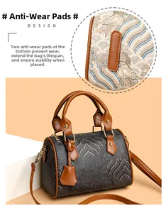 Detail view of the bottom wear-resistant pads on a retro Boston style handbag