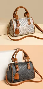 Close-up of litchi leather handles and jacquard fabric on Boston style handbags