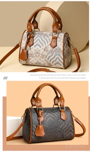 Detail of Boston bag showing jacquard fabric texture and leather handles in two colors