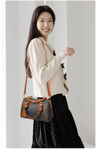 Detail of vintage Boston bag featuring retro patterns and caramel leather contrast straps