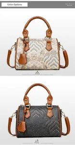 Comparison of white and black jacquard Boston handbags with brown leather straps
