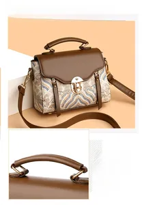Detail of elegant top handle and vintage jacquard fabric on the retro square handbag