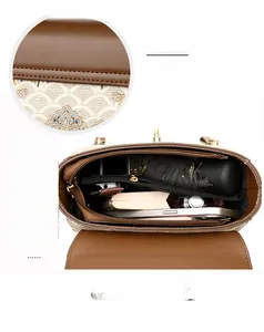 Detailed internal view of large brown leather tote showing spacious multi-pocket storage