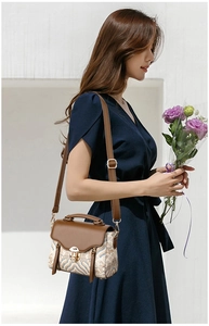 Detailed side view of vintage crossbody bag with wave pattern and leather tassel