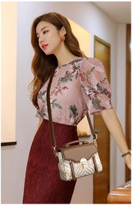Detailed macro of vintage tapestry handbag with gold lock and premium leather flap