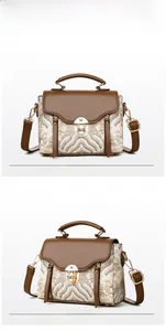 Detail view of the large capacity crossbody bag with brown leather flap and wave embroidery