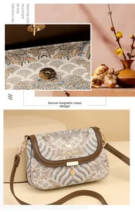 Detailed close-up of a vintage embroidered square bag with secure magnetic closure buckle