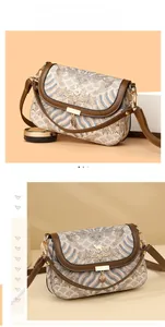 Close-up of ethnic patterned crossbody bag with metallic leaf charm and kangaroo logo