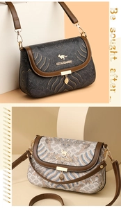 Detail of embroidered fabric flap with golden leaf pendant and leather trim on bag