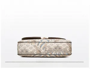 Close-up of the reinforced bottom with ethnic cloud patterns on a square shoulder bag
