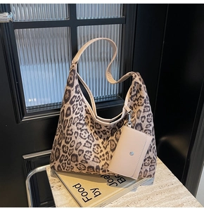 Detail of leopard print hobo bag with matching mini zip pouch and beige straps