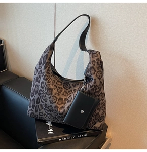 Detail of leopard print tote bag with detachable leather pouch on a fashion magazine