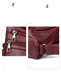 Détail du sac en cuir litchi rouge foncé avec plusieurs fermetures éclair et anneaux