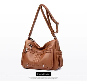 Vue détaillée du sac à bandoulière grande capacité avec fermetures éclair et texture litchi