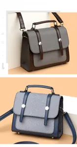 Dettaglio borsa vintage in tela e pelle con fibbia in metallo argentato lucido