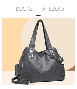 Dettaglio della borsa a trapezio grigio scuro con pelle martellata e zip laterale