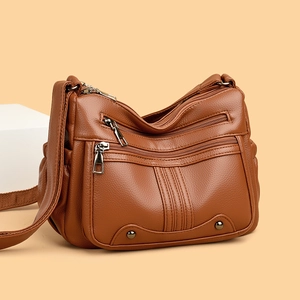 Sac à bandoulière en cuir souple marron avec plusieurs poches zippées de luxe