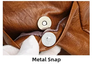Dettaglio della chiusura magnetica in metallo su borsa in pelle martellata marrone