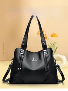 Elegant black lychee leather handbag detail with silver kangaroo logo and tassel charm