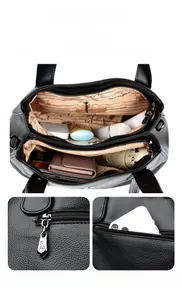 Detail view of large capacity tote bag with multi-compartment interior and security back pocket