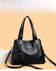 Close-up of black lychee textured tote bag with silver kangaroo logo and tassel details