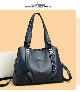 Detail of navy blue pebble leather tote bag with KANGDAISHA logo and metal hardware