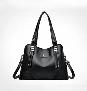 Front view of black pebble leather tote bag with kangaroo logo and tassel details