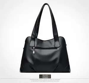 Back view of black pebbled leather tote bag with functional exterior zipper pocket