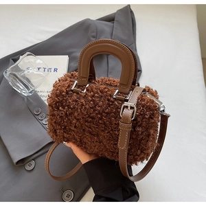 Detailed close-up of brown faux shearling handbag showing soft wool texture and leather handle