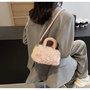 Détail du sac boîte en peluche rose montrant la texture douce et l'anse en cuir