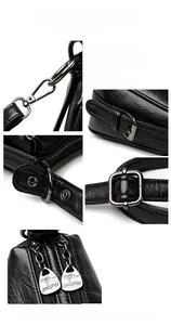Close-up of polished gunmetal hardware and kangaroo logo on black leather shoulder bag