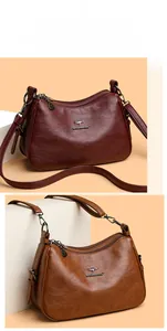 Close-up of wine red and brown leather shoulder bags with elegant texture and metal details