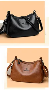 Detail of premium textured leather crossbody bags with kangaroo logo and zipper closure