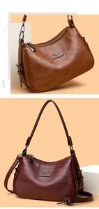 Detail of high-quality pebbled leather crossbody bags with kangaroo logo and zip pockets
