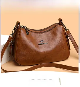 Detailed view of brown lychee grain leather handbag with multi-layer zipper and kangaroo logo