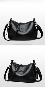 Detailed view of the black leather shoulder bag with metallic kangaroo logo and texture